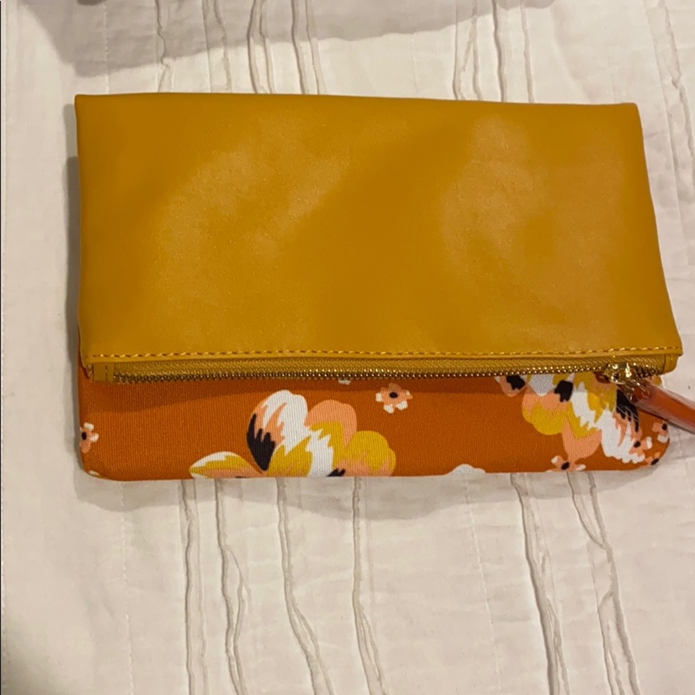 A yellow and orange floral clutch